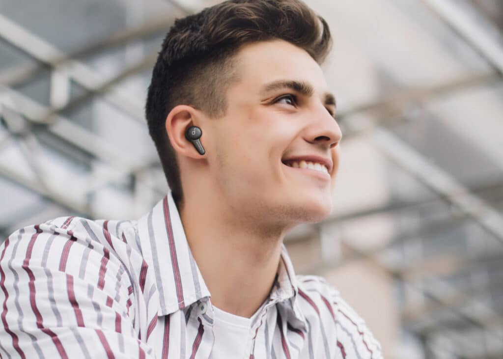 Tradeshow attendee with banded bluetooth earbud.